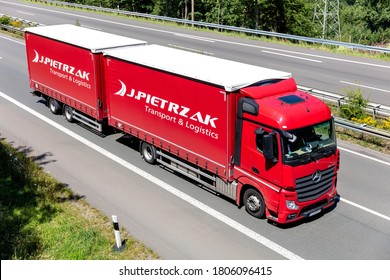 WIEHL, GERMANY - JUNE 26, 2020: J. Pietrzak Mercedes-Benz Actros curtainside combination truck on motorway.