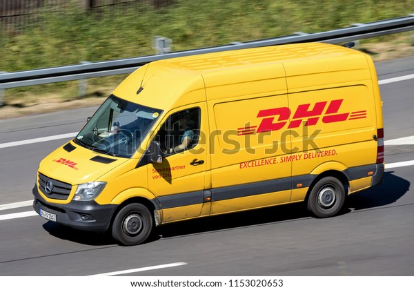 WIEHL, GERMANY -\
JUNE 29, 2018: DHL delivery van on Motorway. DHL is a division of\
the German logistics company Deutsche Post AG providing\
international express mail\
services.