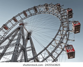 Wiener Riesenrad in Vienna, Austria. Historic tall Ferris wheel with red gondolas at the entrance of the Prater amusement park.  - Powered by Shutterstock