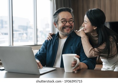 The wife brought coffee for her husband while working in the living room. The wife encourages her husband to work. - Powered by Shutterstock