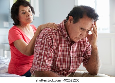 Wife Comforting Senior Husband Suffering With Dementia
