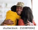 Wife And Daughter Embracing Happy Black Soldier Man After Returning Home From Army, Excited African American Male In Military Uniform Hugging With Family And Smiling At Camera, Closeup Shot