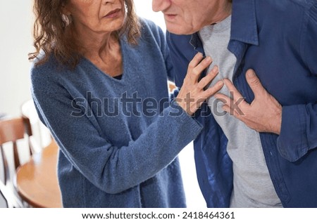 Wife giving husband first aid during heart attack and chest pain Imagine de stoc © 