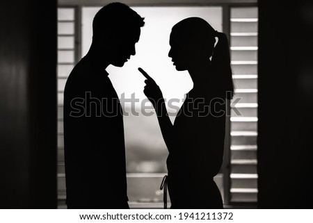Wife at home nagging verbally abusing her husband. Marriage, relationship problems and divorce concept. 
