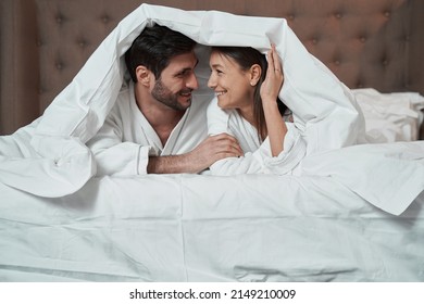 Wife And Husband In Bed Under Blanket