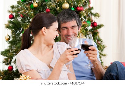 Wife And Husband Couple Drinking Wine At Homa At Christmas Time