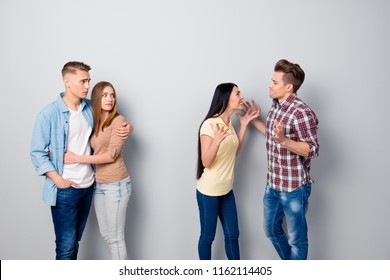 Wife And Husband Quarrel Gesticulating With Their Friends Stand Near To Bewildered Embarrassed Friends Isolated On Light Gray Background