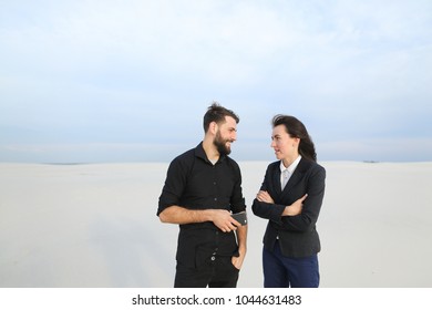 wife and husband using tablet, married couple stop in secluded place after work. Fair-haired female and bearded male searching for resorts planning summer vacation laughing. Concept of innovat