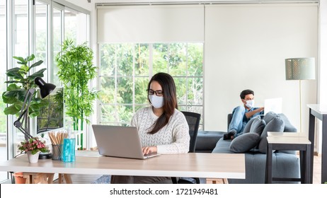 Wife And Husband Working At Home During Lock Down Period Of Corona Virus Out Break With Social Distancing Or Physical Distancing And Wearing Mask To Protect Tion From Virus