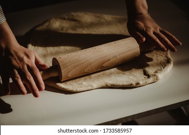Wife making a homemade doughy pastry food with smoked cheese during Ramadan for dinner during the sunset light in the home on the wooden table - Shutterstock ID 1733585957