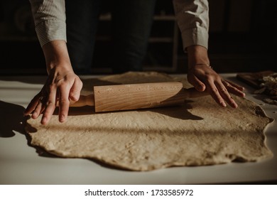 Wife making a homemade doughy pastry food with smoked cheese during Ramadan for dinner during the sunset light in the home on the wooden table - Shutterstock ID 1733585972