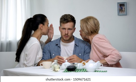 Wife And Mother-in Law In Quarrel Whispering Man On Ear, Family Confrontation