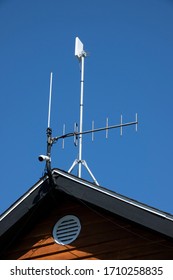 A Wifi Antenna And A Camera On A Building Roof