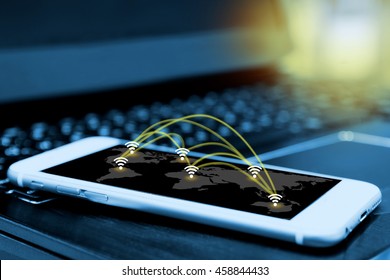 Wifi Icon And Network Connection Concept And Smartphone Screen With Blur Laptop Background ,  Wireless Communication Network , Internet Of Things , Flare Light