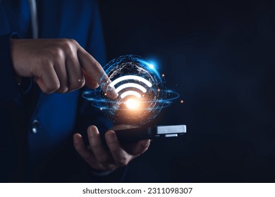 Wifi internet access concept. man using smartphone connect communication, social network, business contact, online shopping via internet wifi hotspot high speed. Fast internet wifi hotspot sharing.  - Powered by Shutterstock