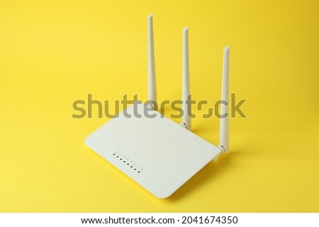 Wi-Fi router with external antennas on yellow background