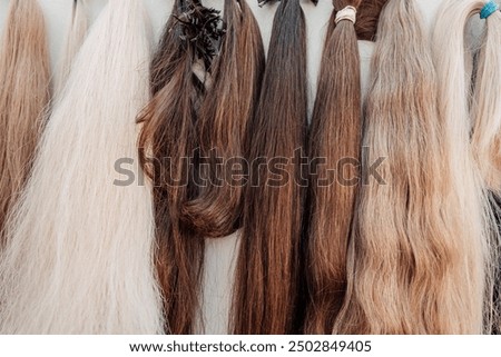 Wig blanks on the wall wig maker. Bundle of natural hair for hair extensions