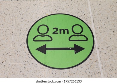 Wigan, Manchester, UK, 16/06/2020, A Green Social Distancing Sticker On The Floor Informing Shoppers To Stay Two Metres Apart During The CoVid Pandemic