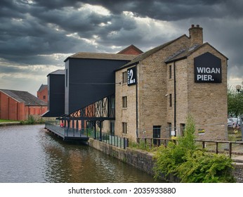 Wigan, UK - Aug 16 2021: Warehouse Buildings At Wigan Pier On The Leeds - Liverpool Canal. Now Under Redevelopment For Housing And Public Access Areas Including A Food Hall And Event Centre.