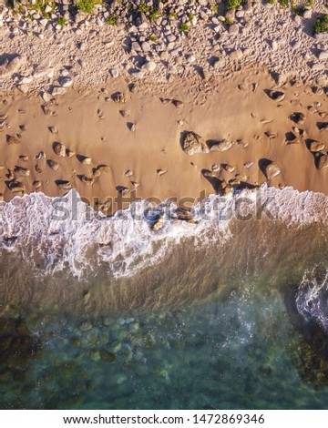 Similar – Luftpanorama-Drohne Blick auf die Meereswellen, die am felsigen Strand erdrücken.