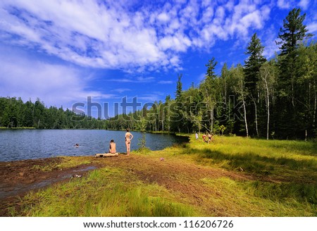 Wild beach on the shore of forest lake. Name Lake - Warm. Irkutsk region. Eastern Siberia