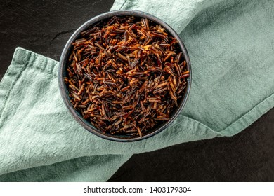 Wild black rice, shot from above on a dark background with copy space