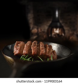 Wild Boar Fillet steak in iron skillet. Selective focus and copy space. The perfect image for your bistro menu cover art.
