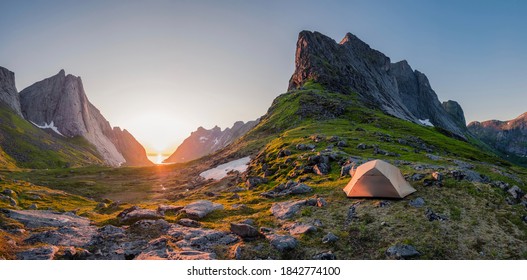 wild camping in the lofoten islands. camping tent among mountains. sunset over camping spot behind polar circle. Panorama of perfect landscape during midnight sun - Shutterstock ID 1842774100