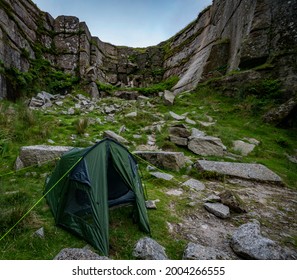 Wild Camping Tent Nestled Between Rocks At Foggintor Quarry, Dartmoor, UK