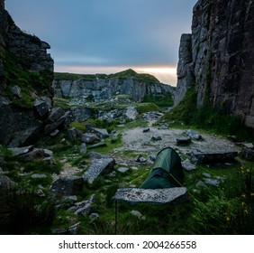 Wild Camping Tent Nestled Between Rocks At Foggintor Quarry, Dartmoor, UK