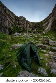 Wild Camping Tent Nestled Between Rocks At Foggintor Quarry, Dartmoor, UK