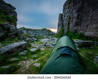 Wild Camping Tent Nestled Between Rocks At Foggintor Quarry, Dartmoor, UK