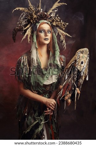 Wild fantasy shaman wizard warloc woman in boho dress and floral crown with horns holing magic stuff in her hand