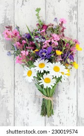 Wild Flower Posy Over Distressed Wooden Background.