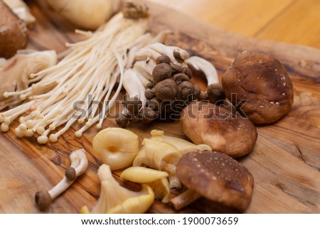 Wild Foraged Mushroom selection on wooden background.
