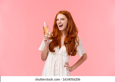 Wild And Free, Joyful Redhead Girl Feeling Awesome And Thrilled, Celebrating, Enjoying Cool Party, Raising Glass, Saying Cheers, Look Sassy And Amused As Drinking Champagne, Celebrating