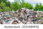 wild garbage dump. residual glass, plastics in the forest