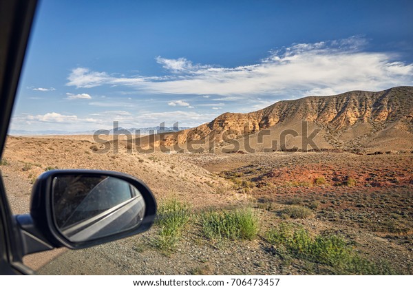 Wild Landscape desert canyons from the window\
of the car on the road in\
Kazakhstan