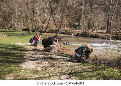 Wild Life Professional Photographer. Exploring Nature Walking Through The  Wood. The Young Researcher Investigating.  Fieldwork Biologist. Three Young Researchers Photographed The River After Fl