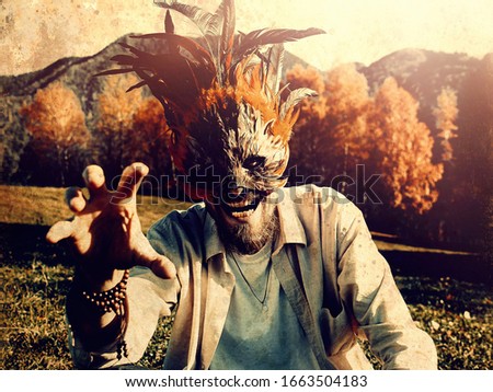 wild man with a colorful feather face mask.