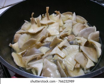 Wild Mushrooms Frying In A Large Silver Wok