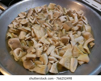 Wild Mushrooms Frying In A Large Silver Wok