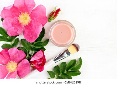 Wild Rose Extract Botanical Beauty Treatment. Aromatic Fresh Pink Flowers, Jar Of  Natural Facial Spa Product - Skincare Mask, Top View White Wooden Table