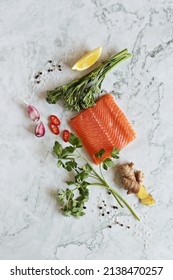 Wild Salmon Fillet With Vegetables And Herbs On A Marble Table. Flat Layot. Copy Space