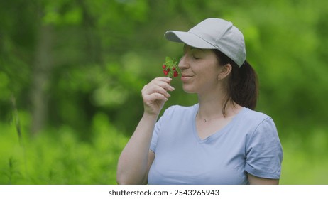 Wild Strawberries Bush. Caucasian European Woman Holding Harvested Wild Strawberry Berries. Slow motion. - Powered by Shutterstock