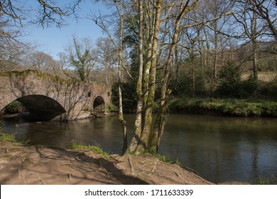 Wild Swimming Pool By An Old Stone Bridge On The Little Dart River In Rural Devon, England, UK