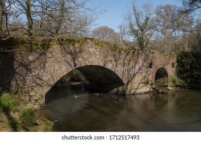 Wild Swimming Pool By An Old Stone Bridge On The Little Dart River In Rural Devon, England, UK