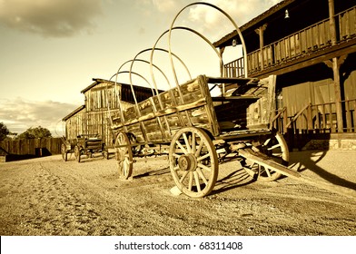 Wild West Cowboy Town With Wagon In Foreground.