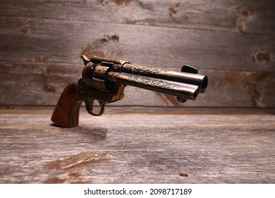wild west gun perspective against barn board background