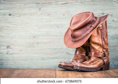 Wild West retro leather cowboy hat and old boots. Vintage instagram style filtered photo